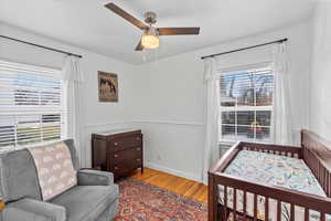 Bedroom with ceiling fan and light hardwood / wood-style flooring