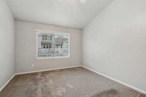 Unfurnished room with ceiling fan and carpet