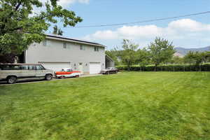 View of yard featuring a mountain view and a garage