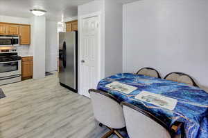 Kitchen featuring stainless steel appliances and light hardwood / wood-style flooring