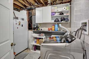 Clothes washing area with washer and dryer and cabinets