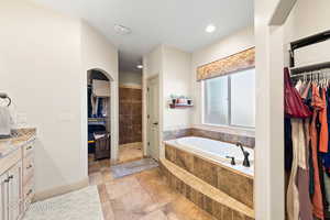 Bathroom with shower with separate bathtub and vanity