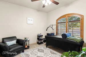 Carpeted office with ceiling fan