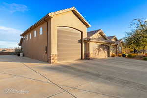 View of property exterior with a garage