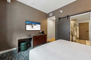 Bedroom featuring a barn door