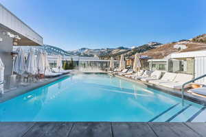 View of pool with a patio and a mountain view