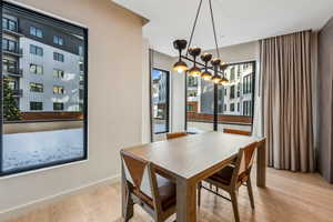 Dining space featuring a chandelier, light wood-type flooring, and a wealth of natural light