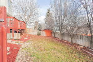 View of yard with a deck and a storage shed