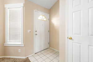 Foyer entrance with light tile patterned floors