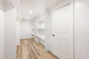 Walk in closet featuring light hardwood / wood-style flooring