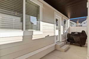 View of patio / terrace with area for grilling with closed fenced area for privacy and a gate to the public park area.