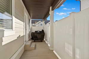 View of patio / terrace with a grill with closed fenced area for privacy and a gate to the public park area