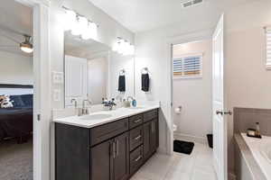 Primary Suite bathroom with double sink and separate tub / shower