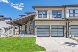 View of front of house with a front lawn and a garage