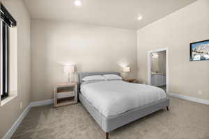 Bedroom with recessed lighting, light colored carpet, baseboards, and connected bathroom