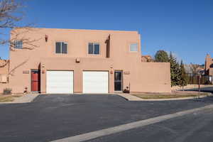 Pueblo-style house with a garage