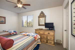 Carpeted bedroom with ceiling fan