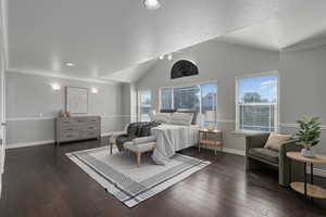 Bedroom featuring dark wood-type flooring, a textured ceiling, vaulted ceiling, and ornamental molding