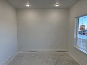 Unfurnished room featuring a textured ceiling and a wealth of natural light