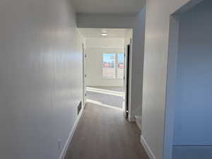 Corridor with dark hardwood / wood-style floors