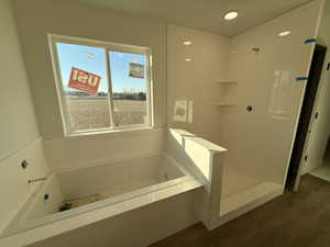 Bathroom featuring a bathing tub and hardwood / wood-style flooring