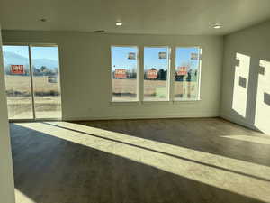 Unfurnished room with wood-type flooring and a mountain view