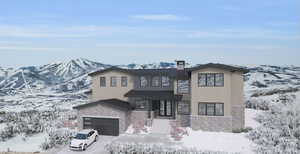 View of front facade with a mountain view and a garage