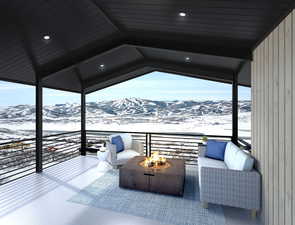 Exterior space with an outdoor fire pit, a balcony, and a mountain view