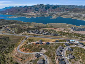 Birds eye view of property with a water and mountain view