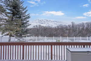 Snow covered deck with a mountain view