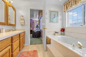 Bathroom with vanity and a relaxing tiled tub