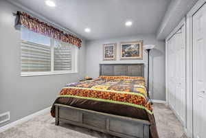 Bedroom featuring light colored carpet