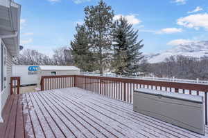 Snow covered deck featuring a mountain view