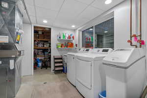 Laundry area featuring washing machine and dryer and heating unit