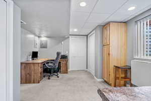 Office featuring electric panel and light colored carpet