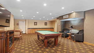 Recreation room with dark carpet and pool table