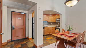 Kitchen featuring sink, light brown cabinetry, tasteful backsplash, and appliances with stainless steel finishes