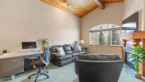 Carpeted office featuring wood ceiling, high vaulted ceiling, and beamed ceiling