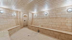 Steam room featuring tile patterned flooring and a tile shower