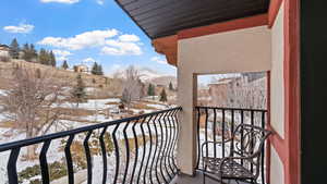 Snow covered back of property featuring a mountain view
