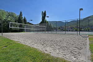 Surrounding community featuring volleyball court, tennis court, and a mountain view