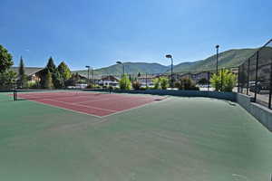 View of tennis court with basketball court and a mountain view