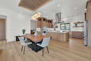 Dining space with light hardwood / wood-style floors