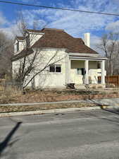 View of side of property featuring covered porch