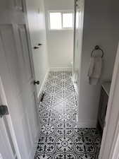 Bathroom with vanity, tile patterned flooring, and walk in shower