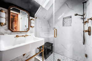 Bathroom with sink and a shower with shower door