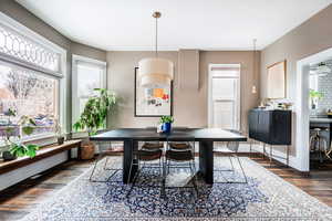 Dining area featuring dark wood-type flooring