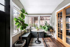 Sunroom featuring vaulted ceiling