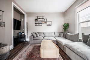 Living room with dark hardwood / wood-style floors