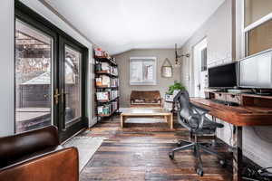 Office space featuring french doors, lofted ceiling, and dark hardwood / wood-style floors